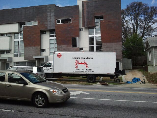 Atlanta Pro Movers truck parked outside a modern townhouse during a residential move in Atlanta.